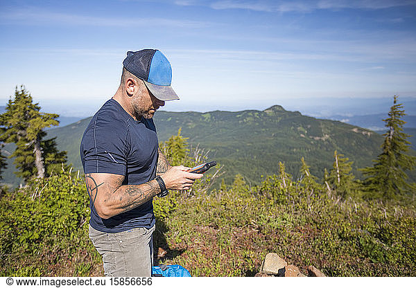 Hiker navigates using a GPS device.