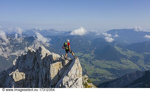 Hiker on a summit on the way to the Hochkalter  mountains and alpine foreland  Bavaria  Germany  Europe