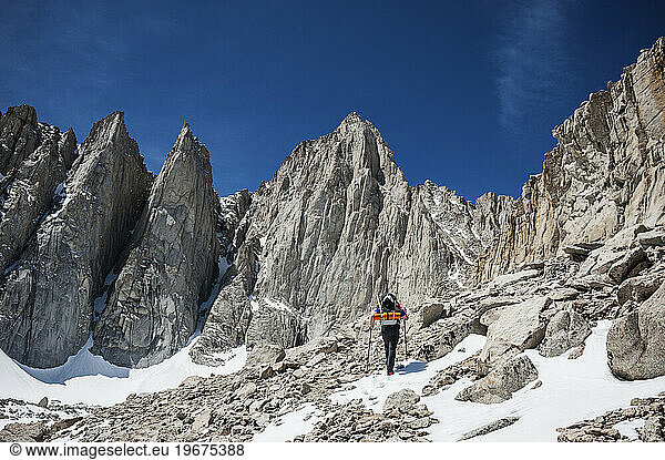 Hiker on approach to Mount Whitney via Mountaineers Route  Sierra Nevada Mountains  California.