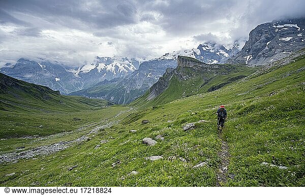 Hiker on hiking trail  Lauterbrunnen  Bernese Alps  Switzerland (Hiker) on hiking trail  Lauterbrunnen  Bernese Alps  Switzerland  Europe