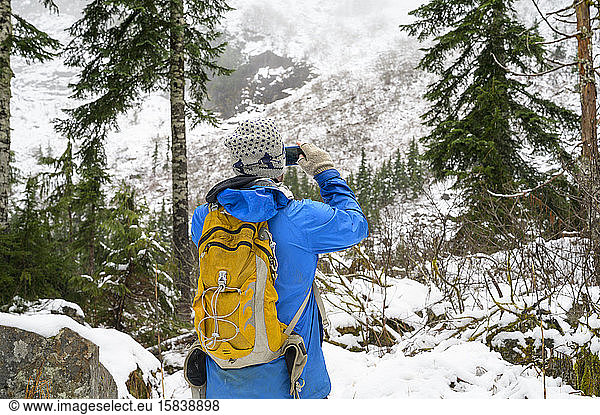 Hiker on snowy trail in the cascade mountains