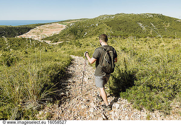 Hiker on stony hiking trail