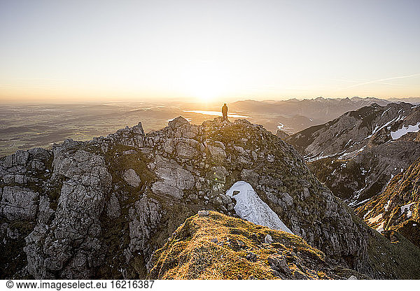Hiker on viewpoint during sunset  Aggenstein  Bavaria  Germany