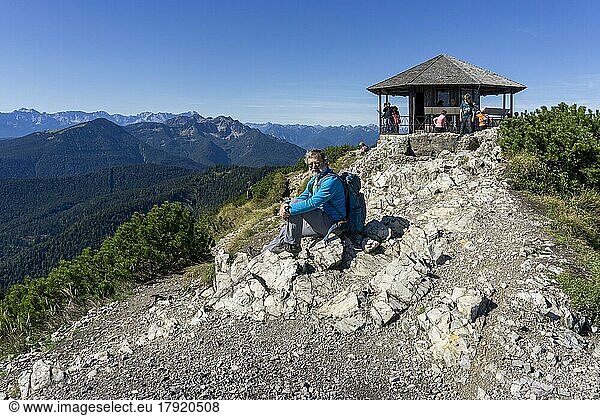 Hiker  senior  64  resting in front of pavilion of King Ludwig II on the Herzogstand  Walchensee  Bavarian Pre-Alps  Upper Bavaria  Germany  Europe