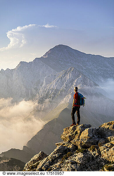 Hiker standing while admiring view of mountain at Bergamasque Alps  Italy