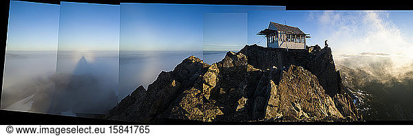Hiker stands at sunrise outside Three Fingers Lookout  North Cascades