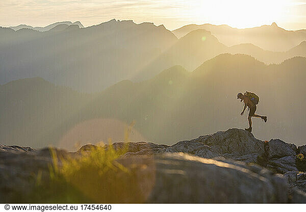 Hiker trips  loses balance on mountain ridge.