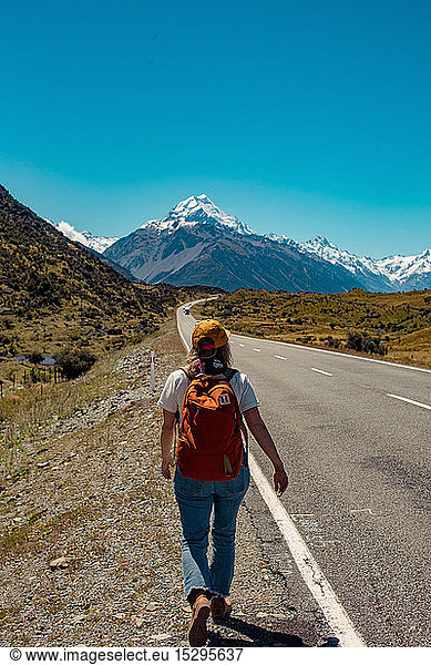 Hiker walking towards mountains  Wanaka  Taranaki  New Zealand