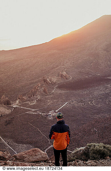 Hiker watching landscape from Guajara Mountain at sunset  Tenerife