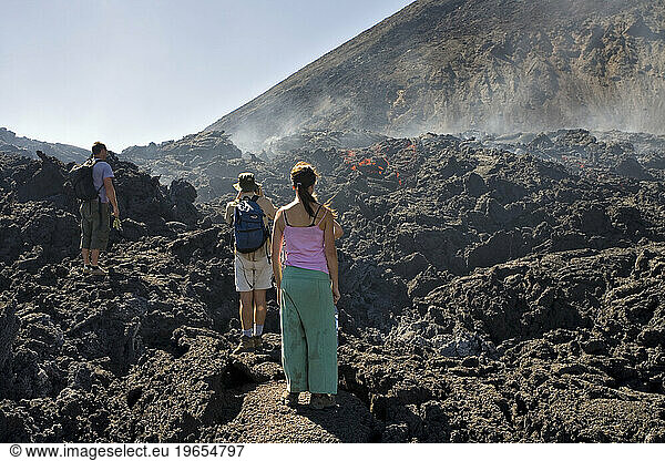 Hikers checking out lava flames on the trail to the active Volcan de Pacaya  Guatemala