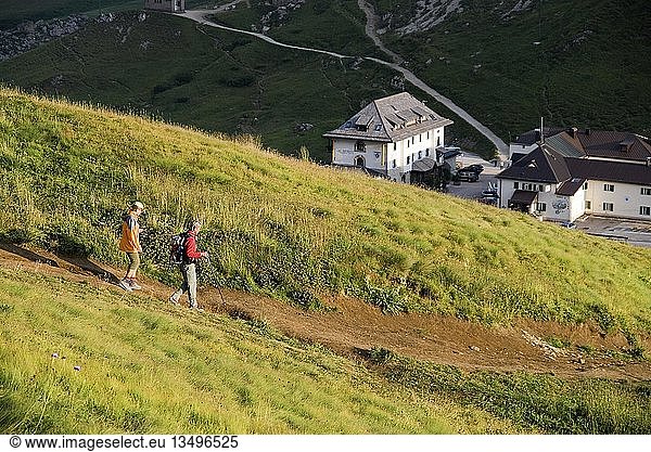 Hikers descending from the Sella massif to the Passo Pordoi in the evening  province of Bolzano-Bozen  Italy  Europe
