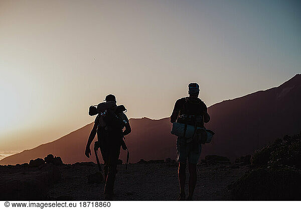 Hikers walking at sunset in Guajara mountain in El Teide