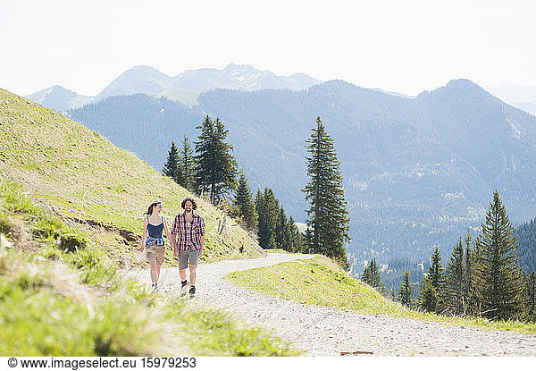 Hiking couple on hiking trail in summer  Wallberg  Bavaria  Germany