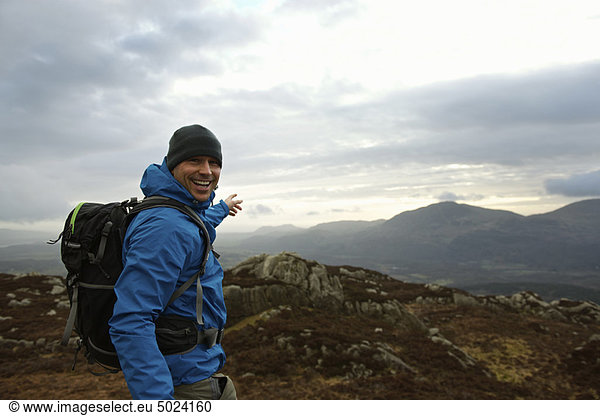 Hiking man admiring mountain view