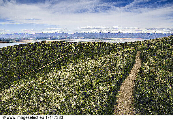 hiking trail winds through lush green grass Frary Peak Antelope Island
