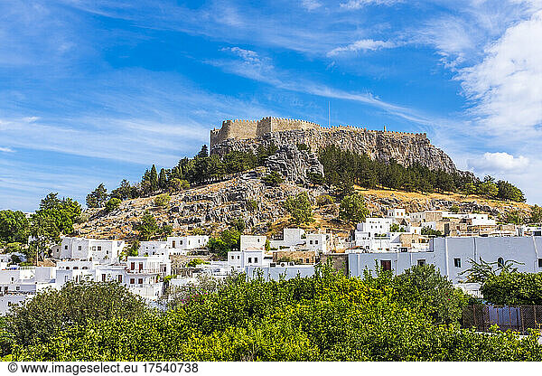 Hill with Acropolis near town of Lindos on sunny day  Rhodes  Greece