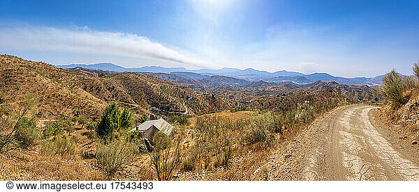 Hills and mountains by empty road on sunny day  Andalucia  Spain  Europe