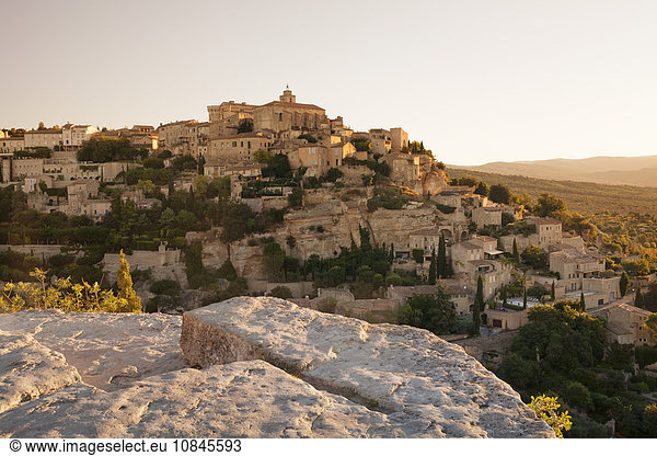 Hilltop village of Gordes with castle and church at sunrise  Provence  Provence-Alpes-Cote d'Azur  Southern France  France  Europe