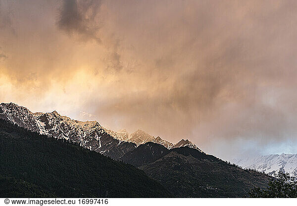 Himalayan peaks at cloudy sunset