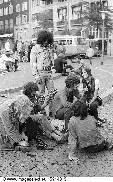 Hippies playing guitar on Dam Square  1970s  Amsterdam  Netherlands
