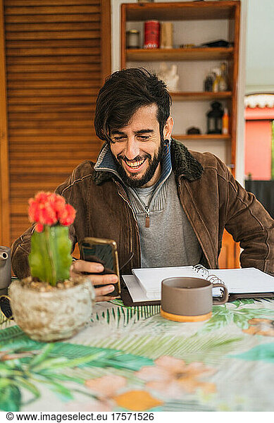 hipster entrepreneur enjoying leisure time at home with mobile