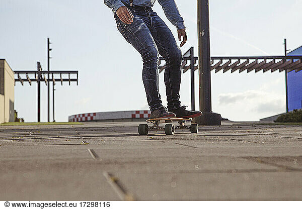 Hipster riding on longboard .