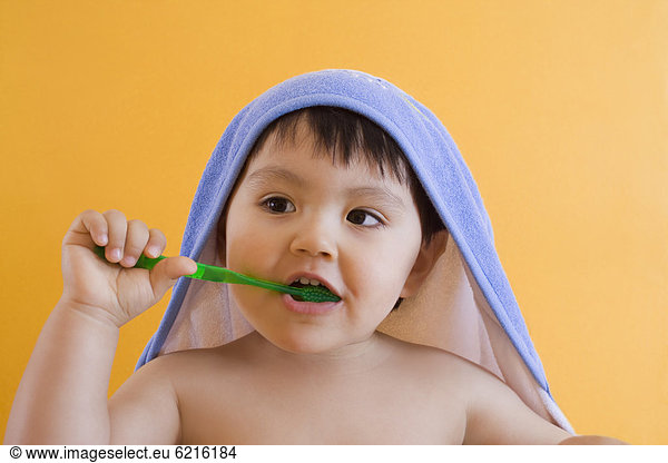 Hispanic boy brushing teeth