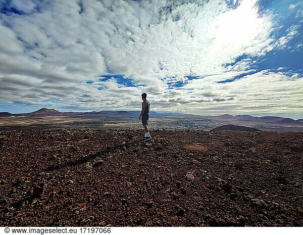 Hispanic man on top of a volcano in Fuerteventura