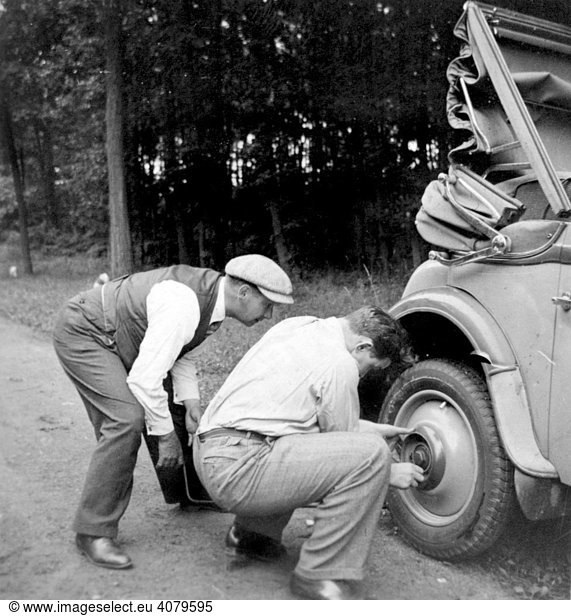 Historic photograph  car with a flat tyre