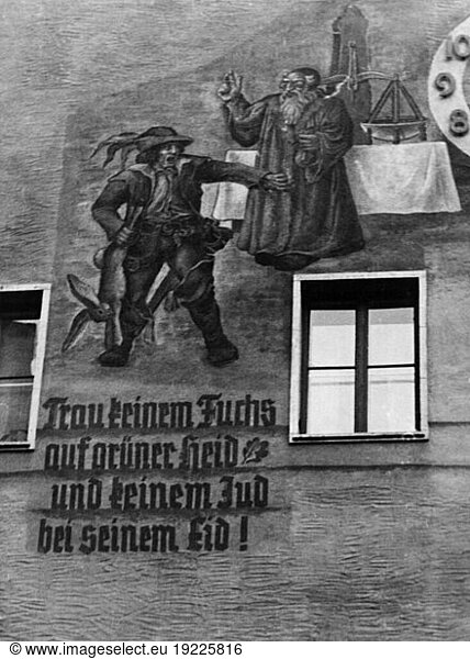 History: Antisemitism. “Neither trust the fox in the forest nor a Jew swearing an oath! (Antisemitic saying and wall painting on the front of a house at Dormitzer Str. 9 in Nuremberg. Photopostcard  undated (1930's ?)