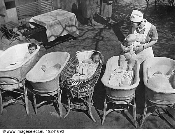 History / Germany / Jews /
Nazi era (1933–45). Jewish nursery in Berlin (Niederschönhausen?): basinets are set up in the garden as a nurse tends to an infant. Photo  Abraham Pisarek  undated (1930s).