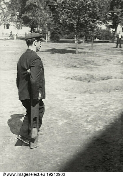 History / Germany / Jews /
Time after war. Jewish UNRRA camp in Berlin-Tempelhof (United Nations Relief and Rehabilitation Administration) for Displaced Persons: outdoor scene  war-disabled man with crutch.
Photo  September 1946 (Abraham Pisarek).