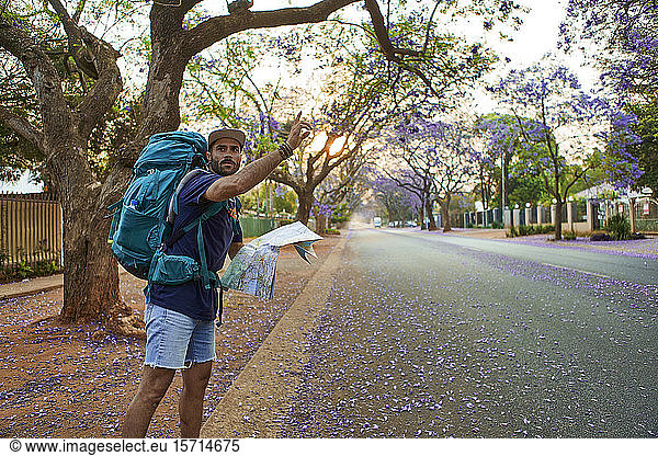 Hitchhiker with map on a street  Pretoria  South Africa