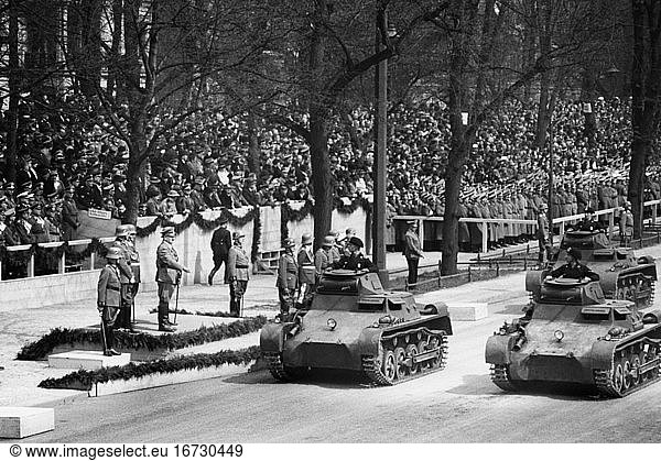 Hitler  Adolf; politician (NSDAP). 1889–1945. Wehrmacht parade on the East-West axis (Charlottenburger Chaussee) in Berlin for Adolf Hitler’s birthday on 20 April 1937: Hitler salutes the passing tank forces. Photo.