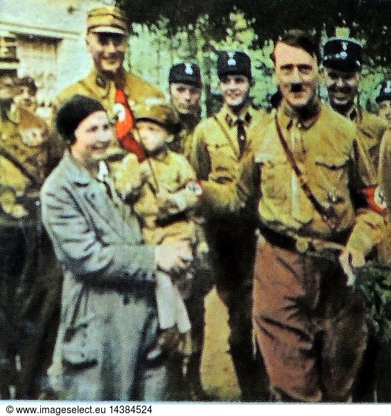 Hitler greets a German Nazi mother with child dressed in Nazi uniform ...