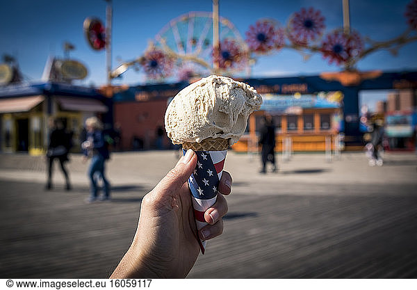 Holding an ice cream cone; Coney Island  Brooklyn  New York  United States of America