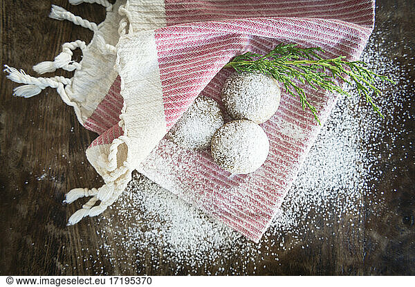 Holiday Cookies Covered with Powdered Sugar on Red and White Napkin