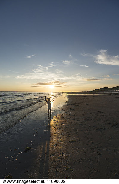 Holland  Westenschouwen  beach  girl on the beach at sunset