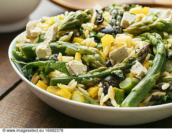 Home made asparagus  spinach orzo salad with vegan feta Cheese