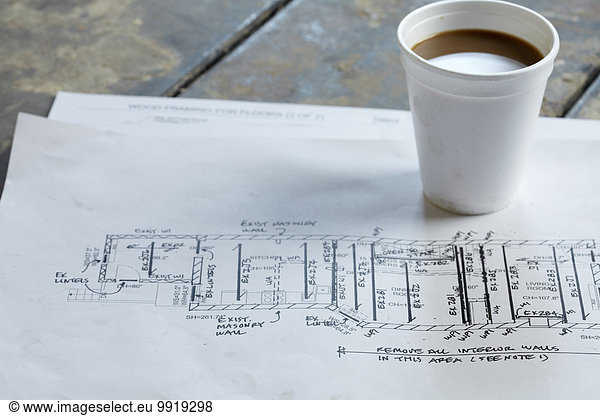 Home Renovation Still Life with Blueprint and Styrofoam Coffee Cup