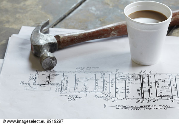 Home Renovation Still Life with Hammer  Blueprint and Styrofoam Coffee Cup
