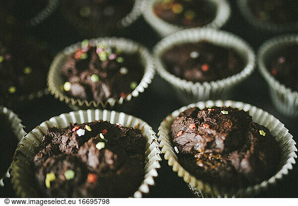 homemade chocolate muffins with colourful toppings