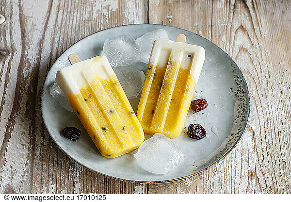 Homemade popsicles with mango and passion fruit