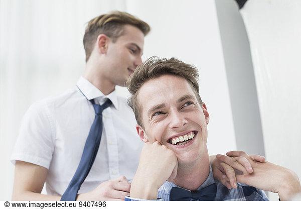 Homosexual couple looking away  smiling