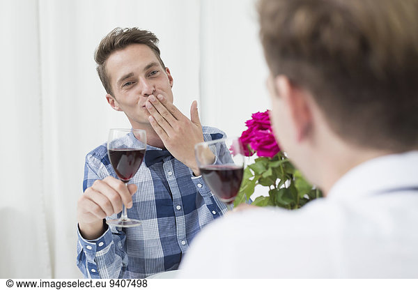 Homosexual couple with red wine