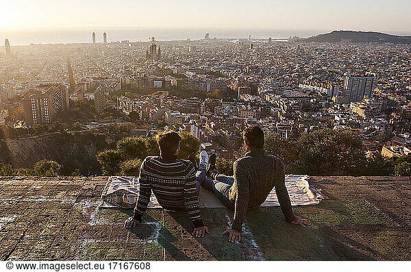 Homosexuell Freunde Blick auf überfüllten Stadtbild beim Sitzen auf Aussichtspunkt  Bunkers del Carmel  Barcelona  Spanien