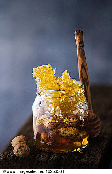 Honeycomb and nuts in jar