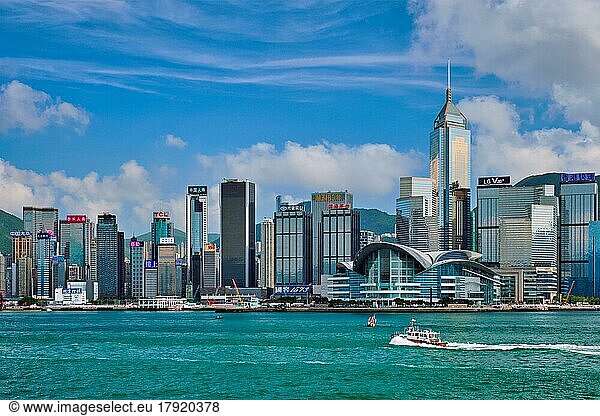 HONG KONG  CHINA  MAY 1  2018: Boat in Victoria Harbour and Hong Kong skyline cityscape downtown skyscrapers over in the day time with clouds. Hong Kong  China. Horizontal camera panning