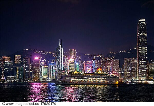 HONG KONG  CHINA  MAY 1  2018: Hong Kong skyline cityscape downtown skyscrapers over Victoria Harbour in the evening illuminated with cruise ship. Hong Kong  China  Asia
