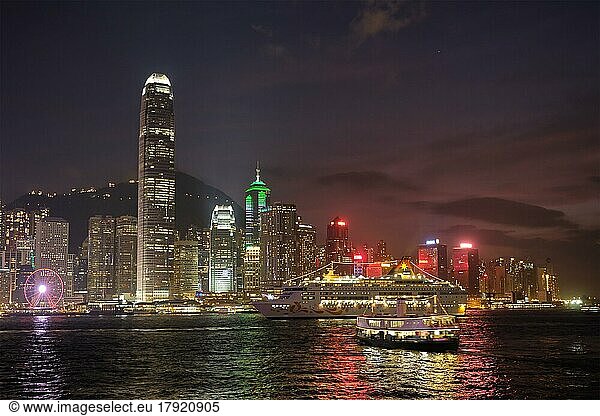 HONG KONG  CHINA  MAY 1  2018: Hong Kong skyline cityscape downtown skyscrapers over Victoria Harbour in the evening illuminated with cruise ship. Hong Kong  China  Asia